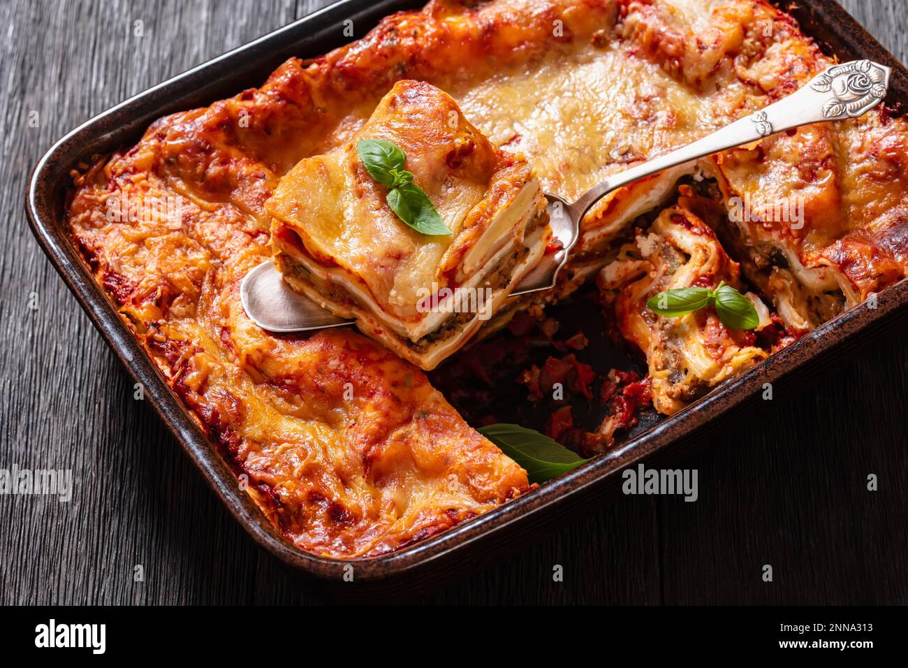 Lasagna with ricotta cheese, ground beef, mushrooms, and tomato sauce