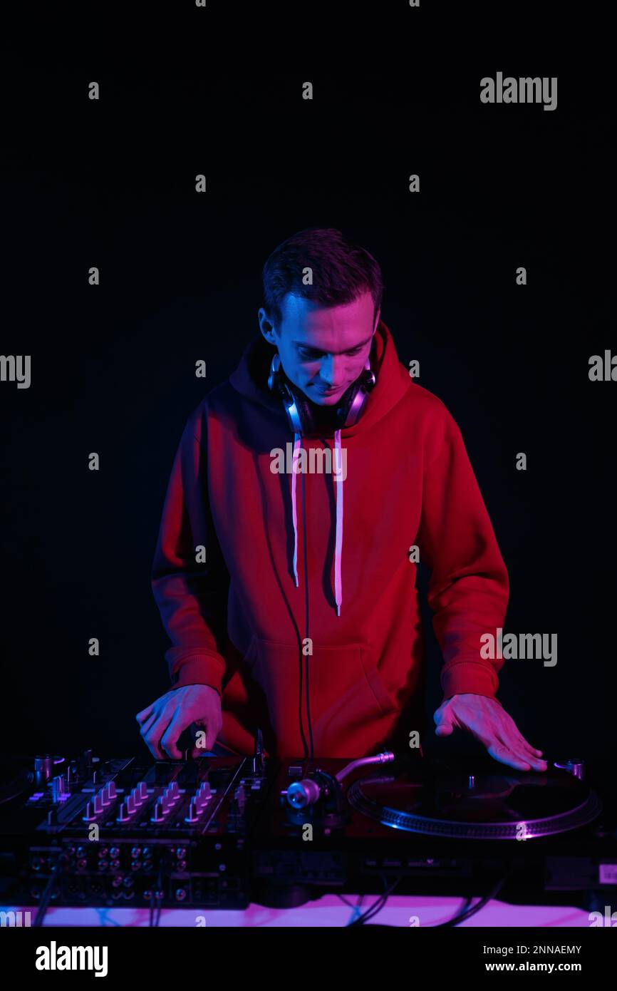 Hip hop DJ scratches records on turntables. Disc jockey mixing vinyl