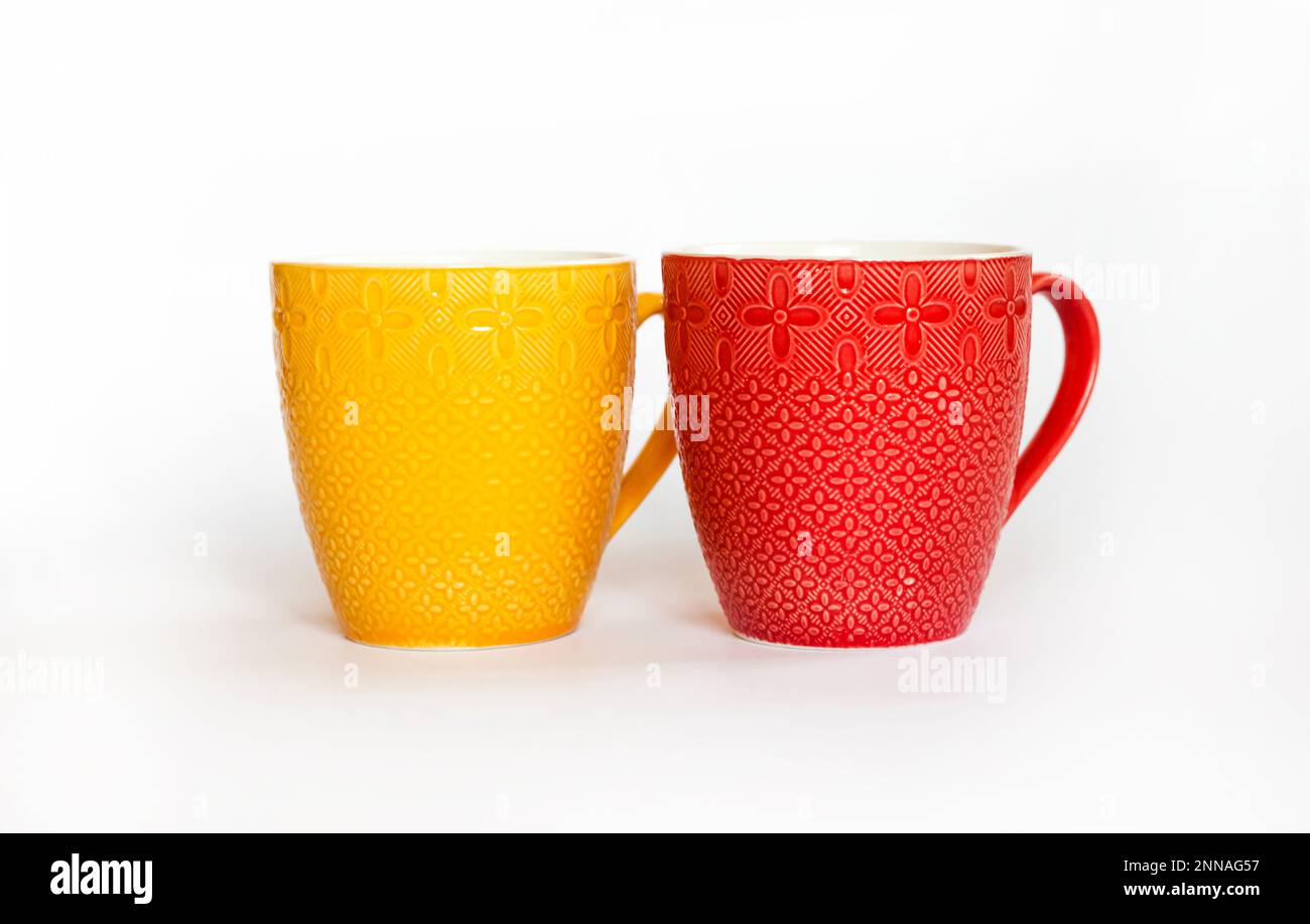 Two colorful mugs isolated on white background Stock Photo