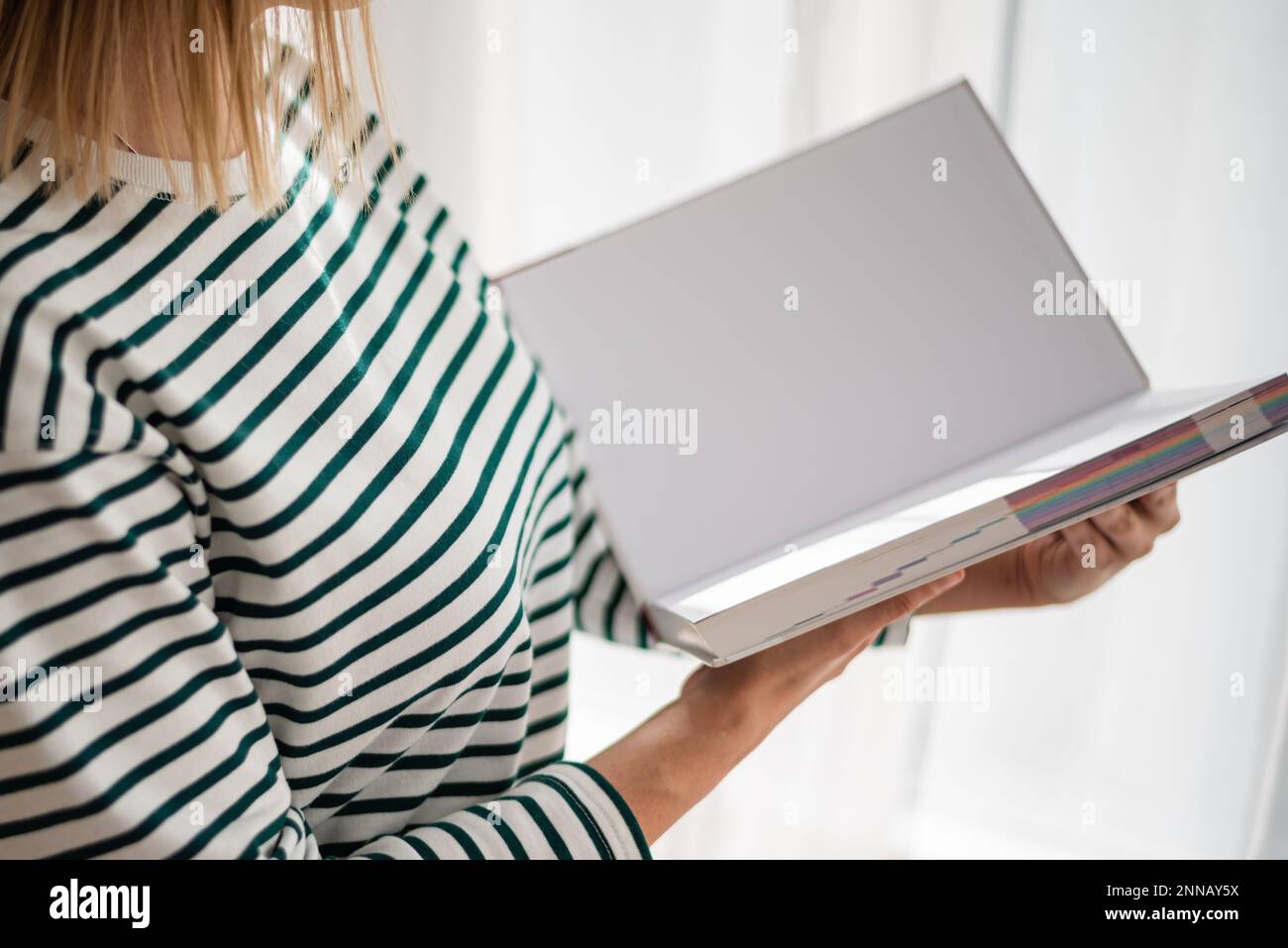 Opened book in hands isolated on white background. Stock Photo