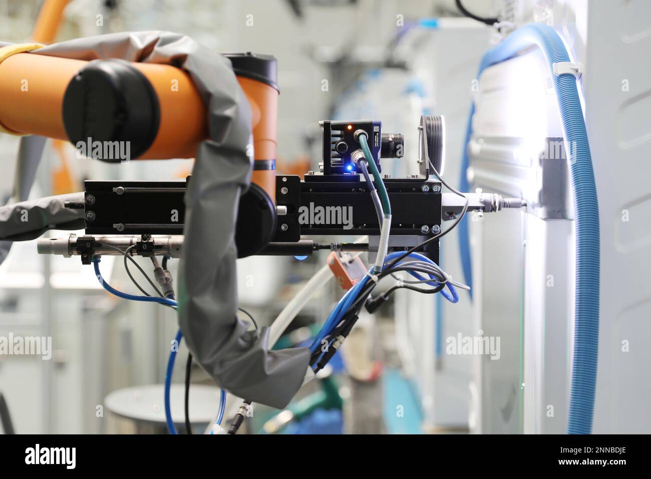 A robot arm with vision works on the assembly line of washing machines at a  5G plant of the home appliance maker Haier in Qingdao in east China's  Shandong province Tuesday, May