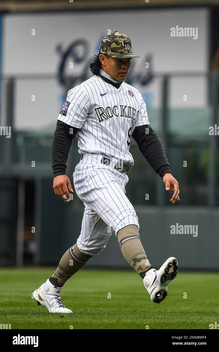 DENVER, CO - May 15: Colorado Rockies first baseman Connor Joe (9) puts a  ball in play and advances the baserunner during a game between the Colorado  Rockies and the Cincinnati Reds