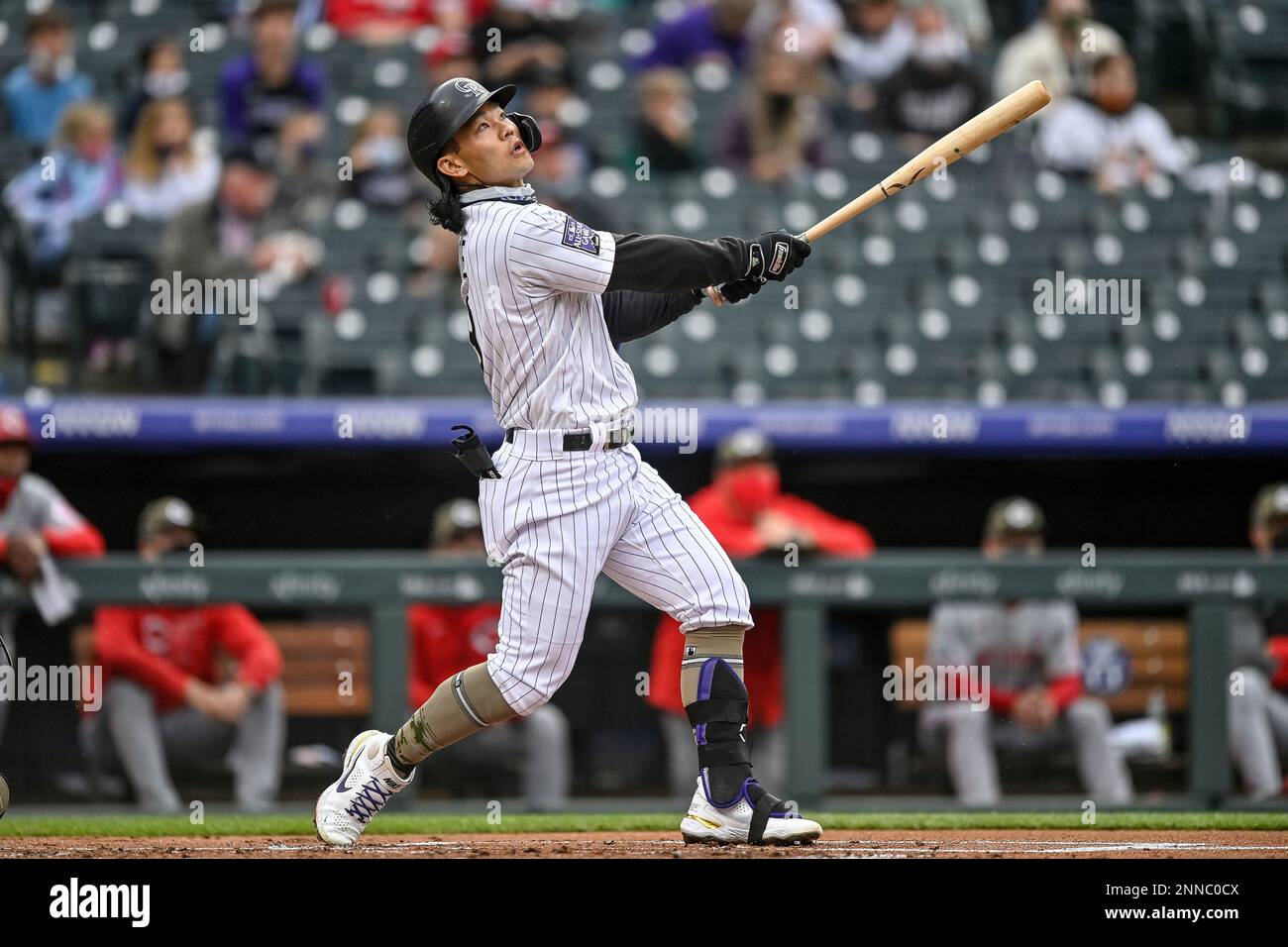 DENVER, CO - May 15: Colorado Rockies first baseman Connor Joe (9) puts a  ball in play and advances the baserunner during a game between the Colorado  Rockies and the Cincinnati Reds