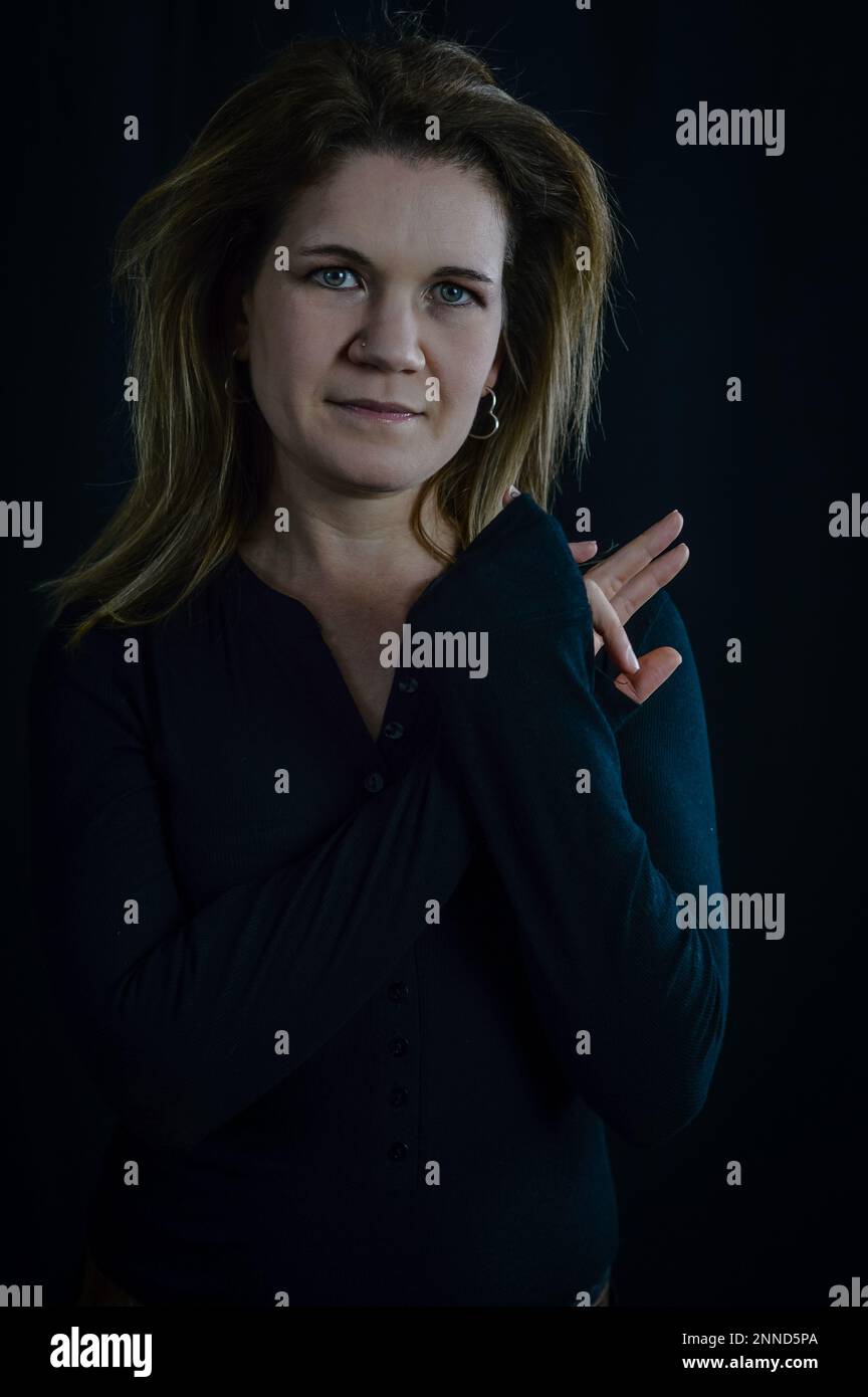 portrait of a beautiful elegant blonde woman with her hands together