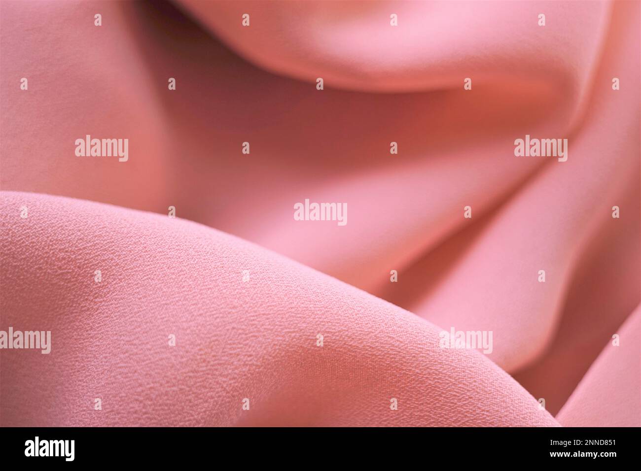 Delicate pale pink thin fabric, beige material chiffon waves. Stock Photo
