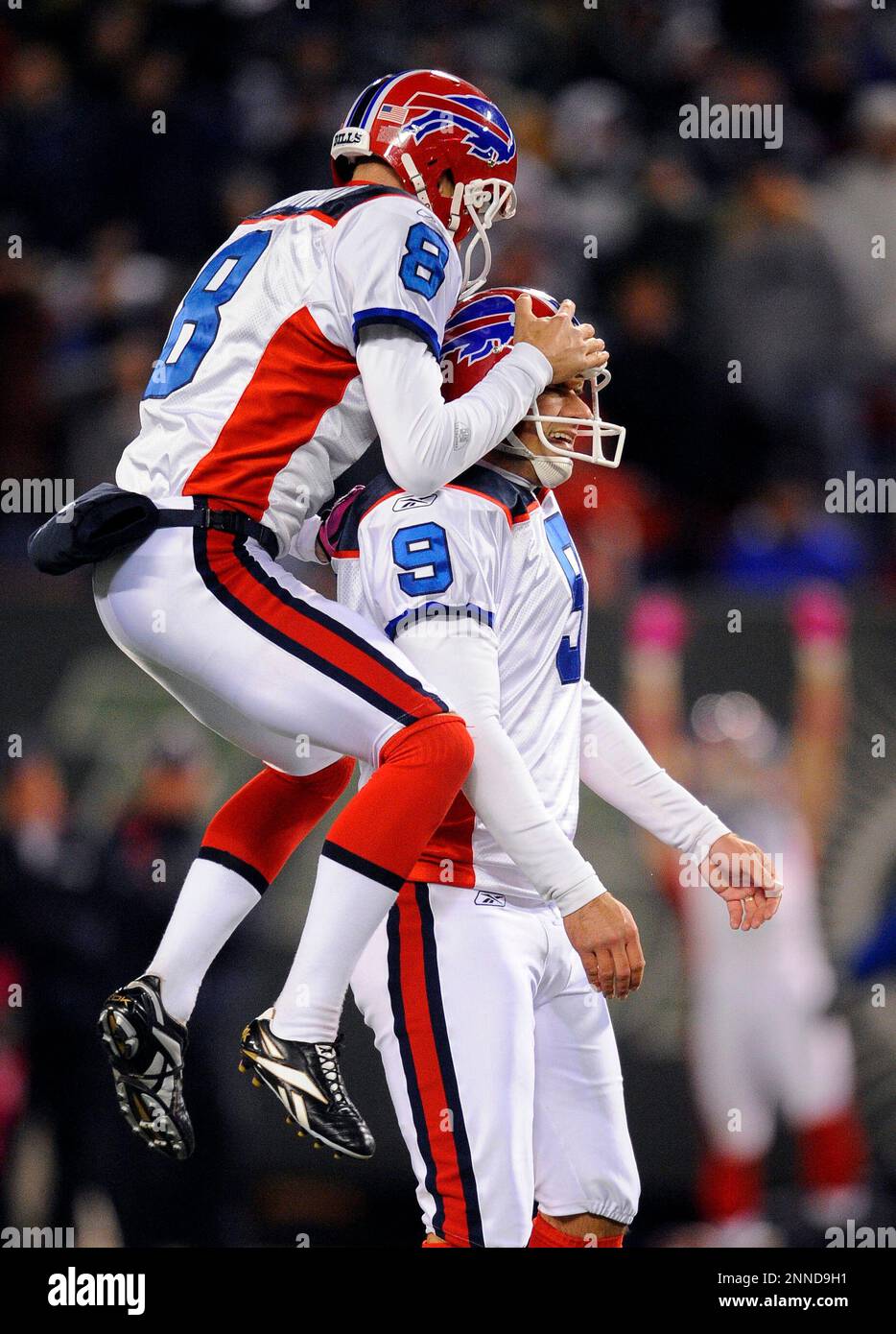 18 October 2009: Buffalo Bills punter Brian Moorman (8) jumps on PK Rian  Lindell (9) after making the game winning 47 yard field goal to defeat the  Jets 16-13 in overtime at