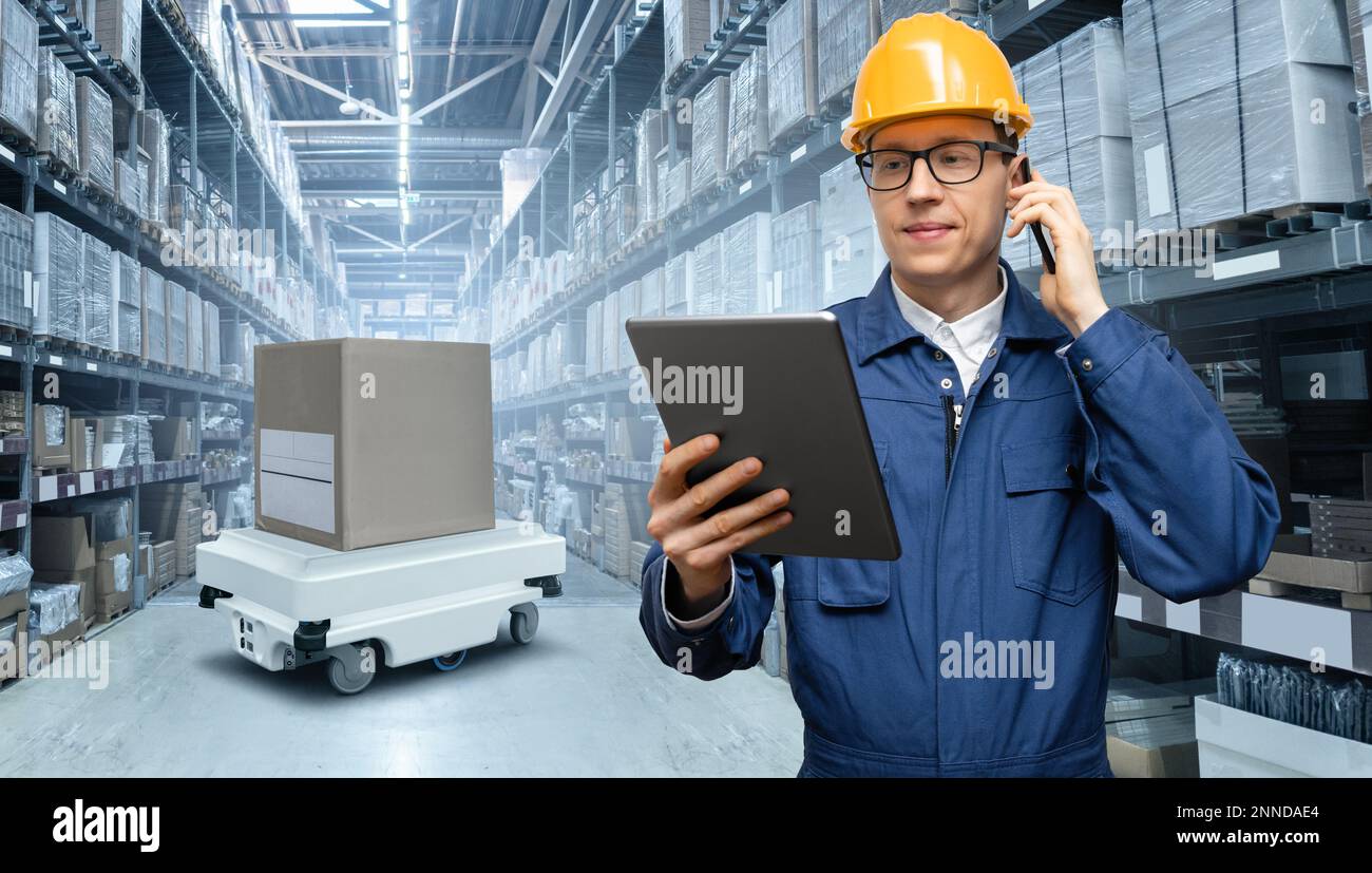 Manager with digital tablet in an automated warehouse Stock Photo