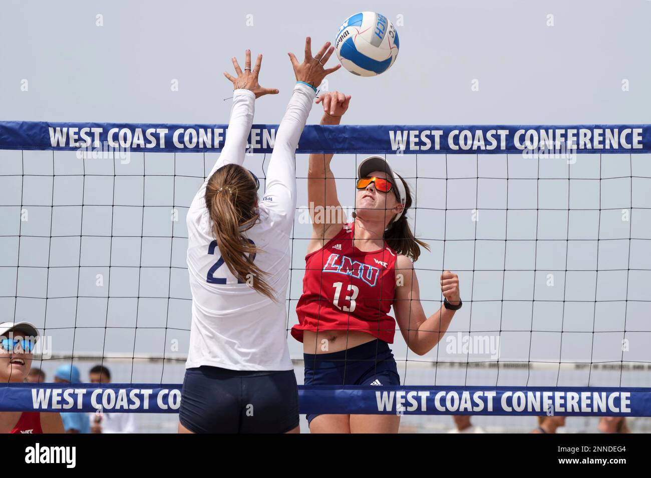 Darby Dunn of Loyola Marymount hits the ball over Gracie Pedersen of Pepperdine (22) during the