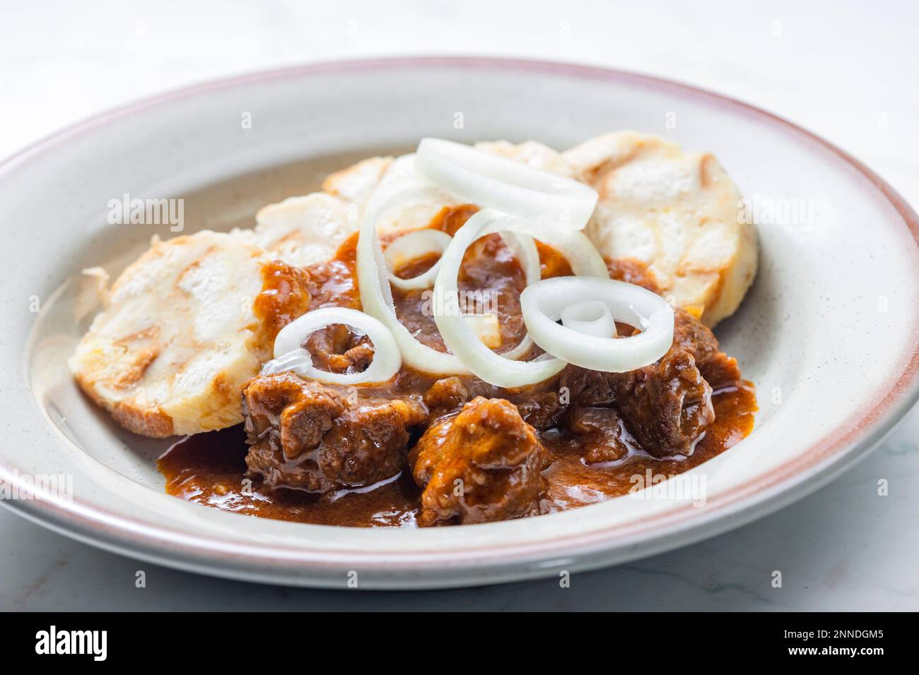 beef goulash with onion rings and dumplings Stock Photo