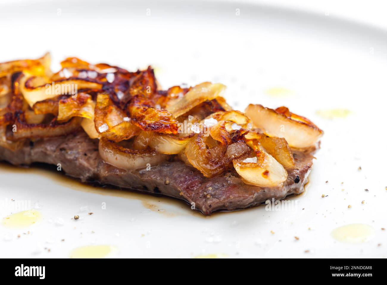 steak covered by caramelized onion Stock Photo Alamy