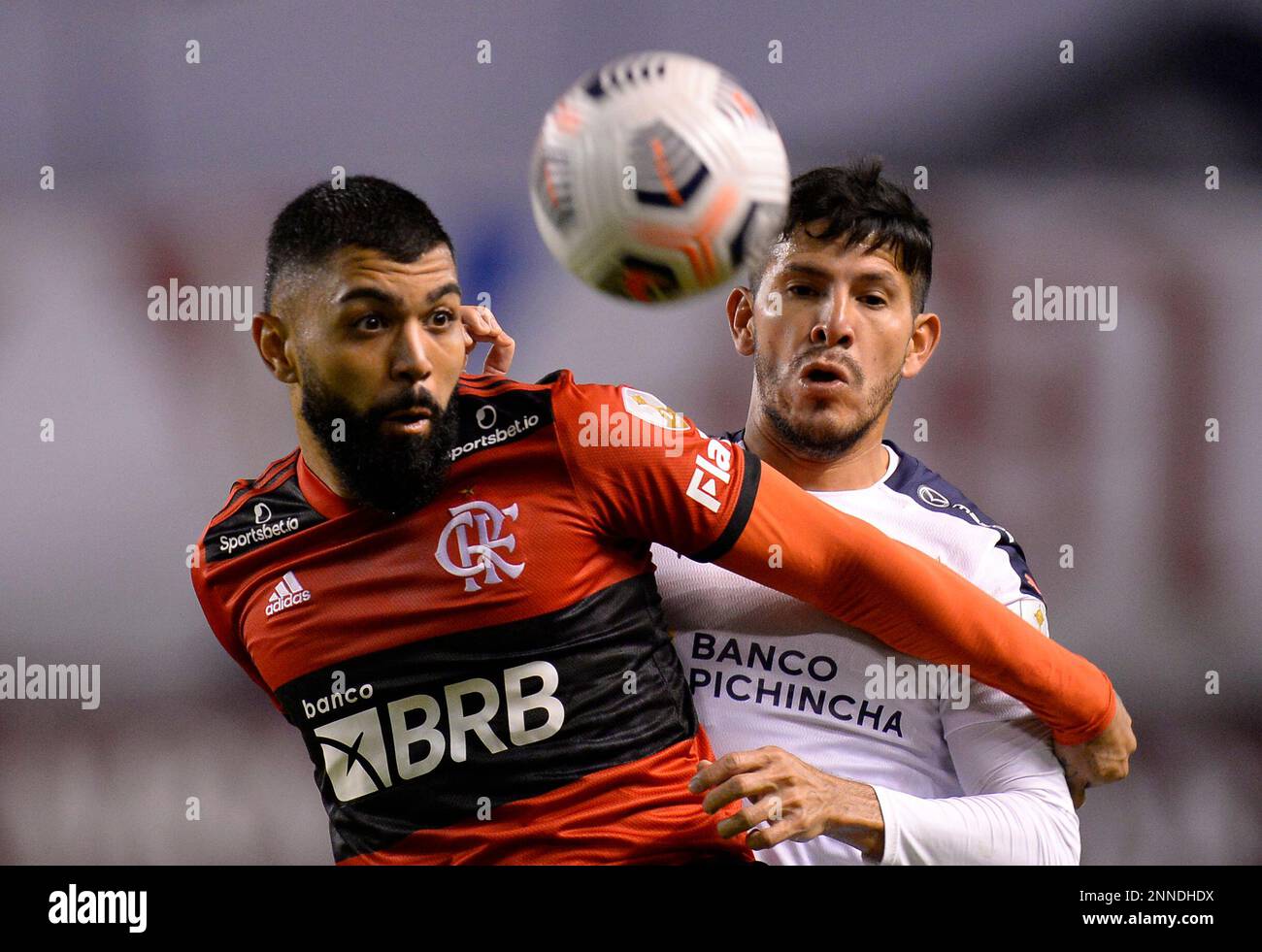 Gabriel Barbosa of Brazil s Flamengo left and Christian Cruz of Ecuador s Liga Deportiva Universitaria battle for the ball during a Copa Libertadores soccer match at Casa Blanca stadium in Quito Ecuad...