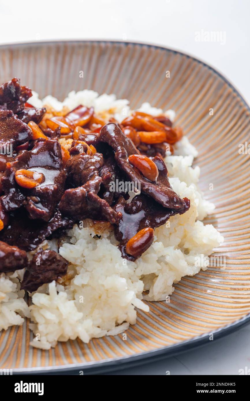 beef meat with soya sauce and peanuts served with white rice Stock