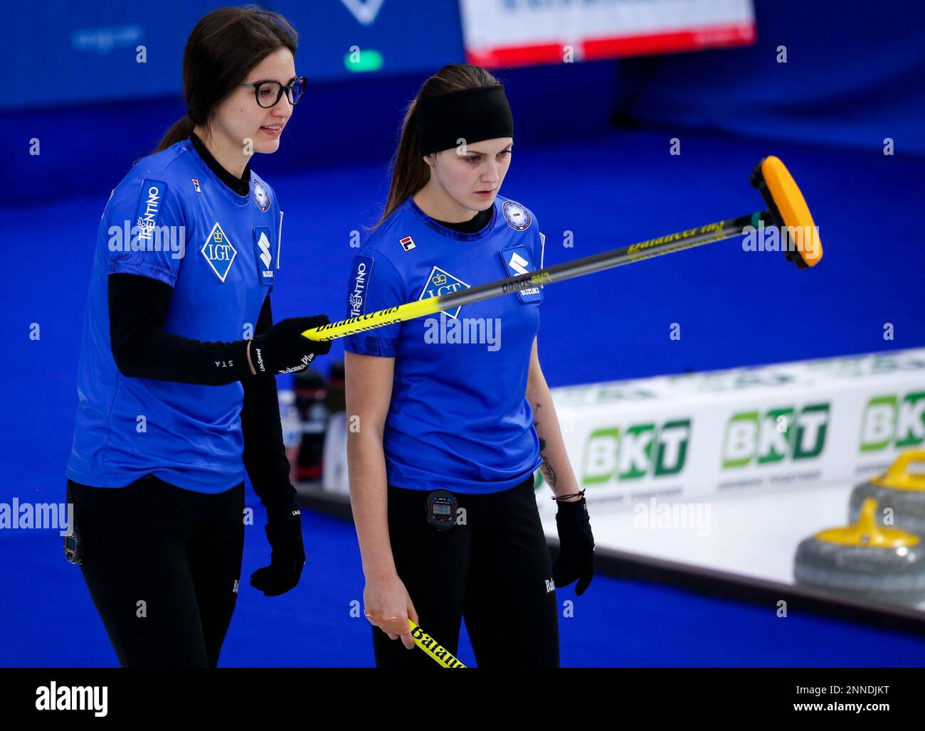 Italy skip Stefania Constantini, left, and third Marta Lo Deserto discuss strategy against Canada at the womens world curling championship in Calgary, Alberta, Tuesday, May 4, 2021
