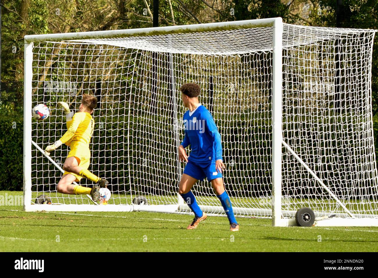 Swansea, Wales. 25 February 2023. Goalkeeper Ewan Griffiths of Swansea City makes a save as Cole Fleming of Cardiff City looks on during the Professional Development League game between Swansea City Under 18 and Cardiff City Under 18 at the Swansea City Academy in Swansea, Wales, UK on 25 February 2023. Credit: Duncan Thomas/Majestic Media/Alamy Live News. Stock Photo