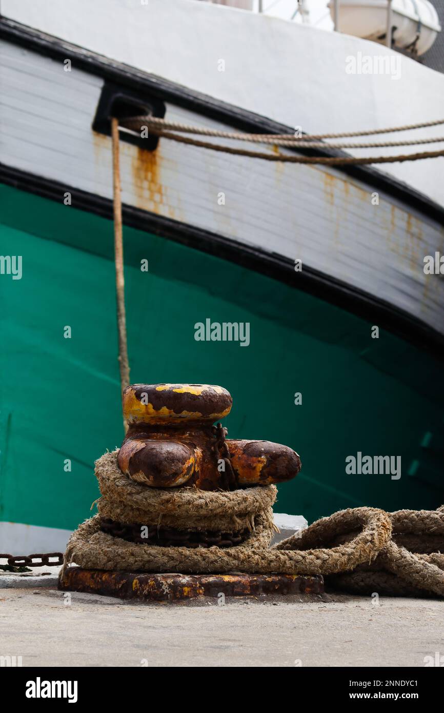 Bollard On Pier With Tied Fishing Trawler Stock Photo