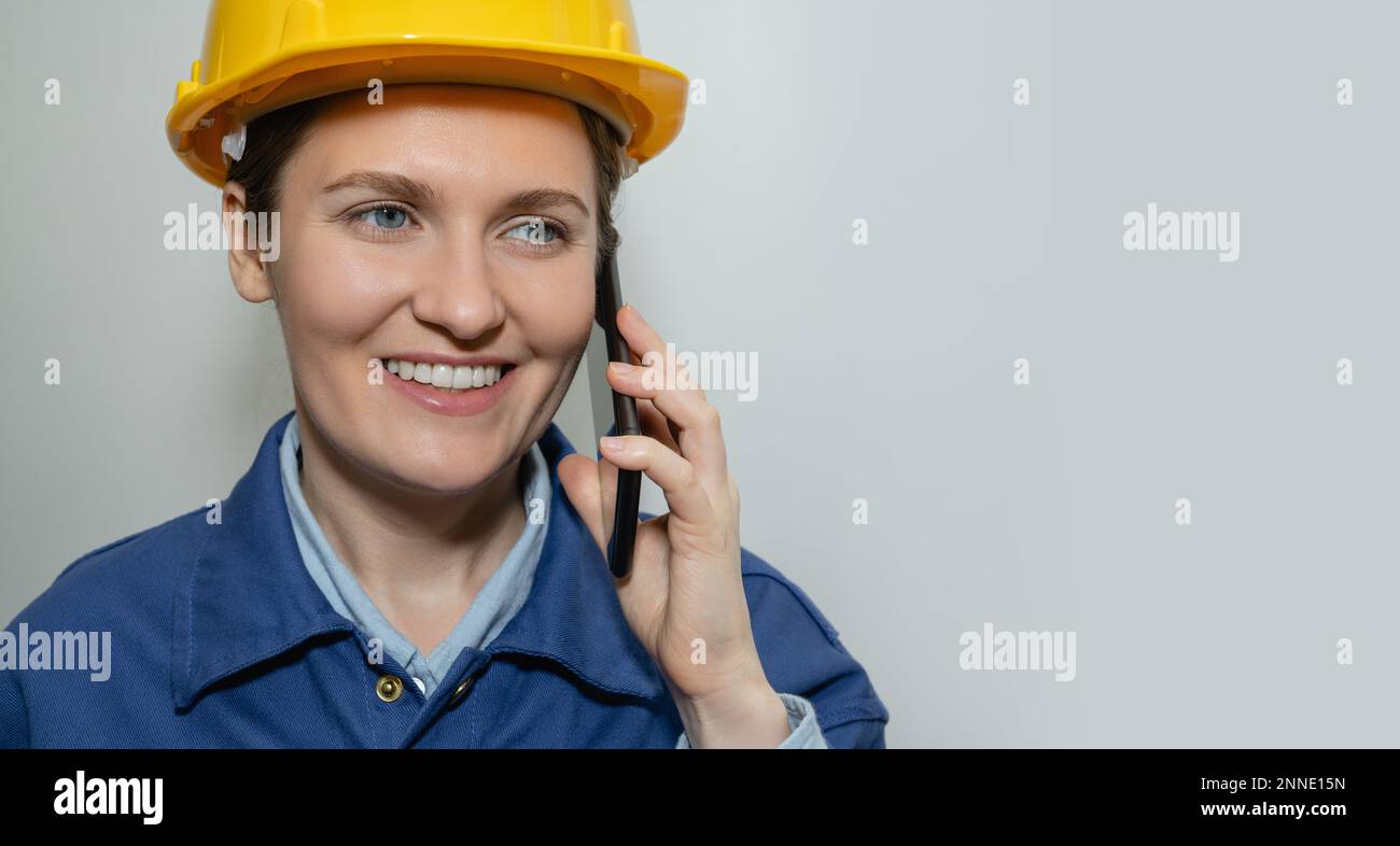 Woman engineer in helmet with mobile phone Stock Photo