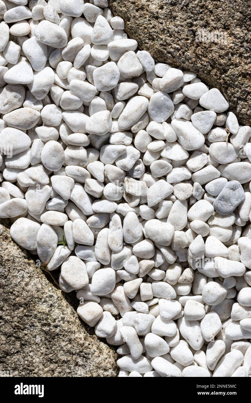 Abstract composition formed by small white stones and granite rocks Stock Photo