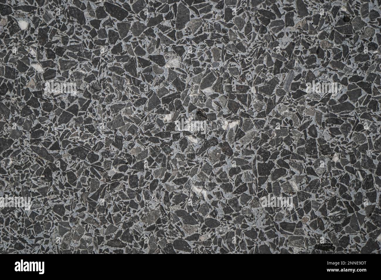 Grunge small dolomite crushed stone texture. Natural grey, white and black colors stone background. High resolution seamless stone backdrop. Copy spac Stock Photo