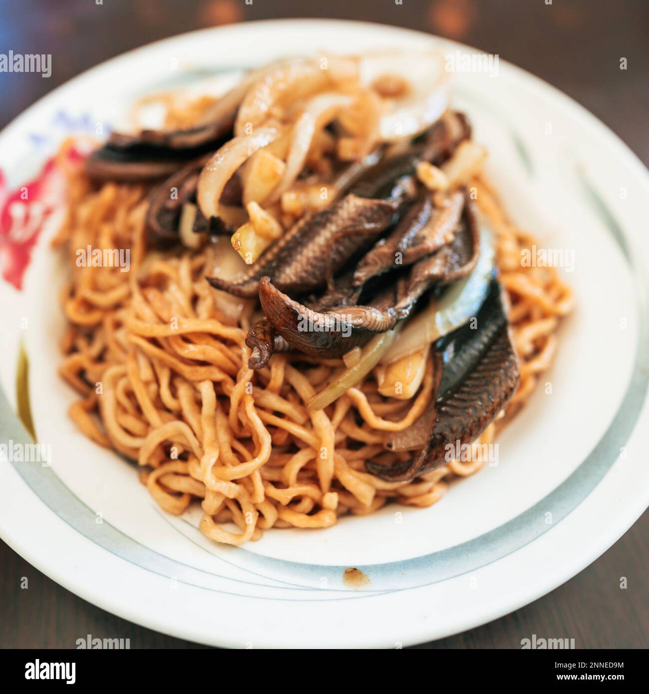 Taiwanese street food - Eel noodles. It's fried eel served over flat noodles in a thick sweet and sour sauce. Stock Photo