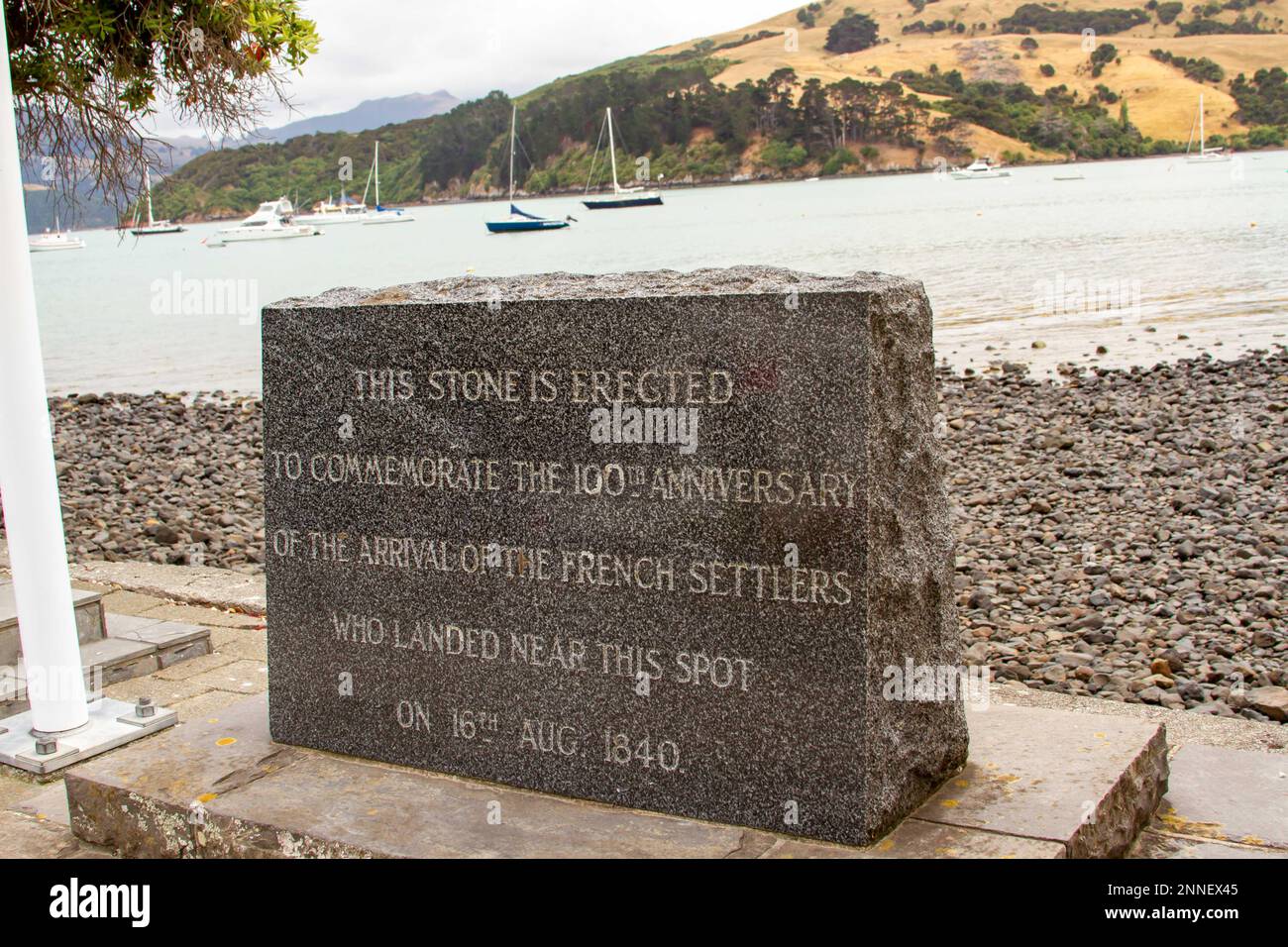 Monument stone to French settlers on waterfront of Akaroa, New Zealand