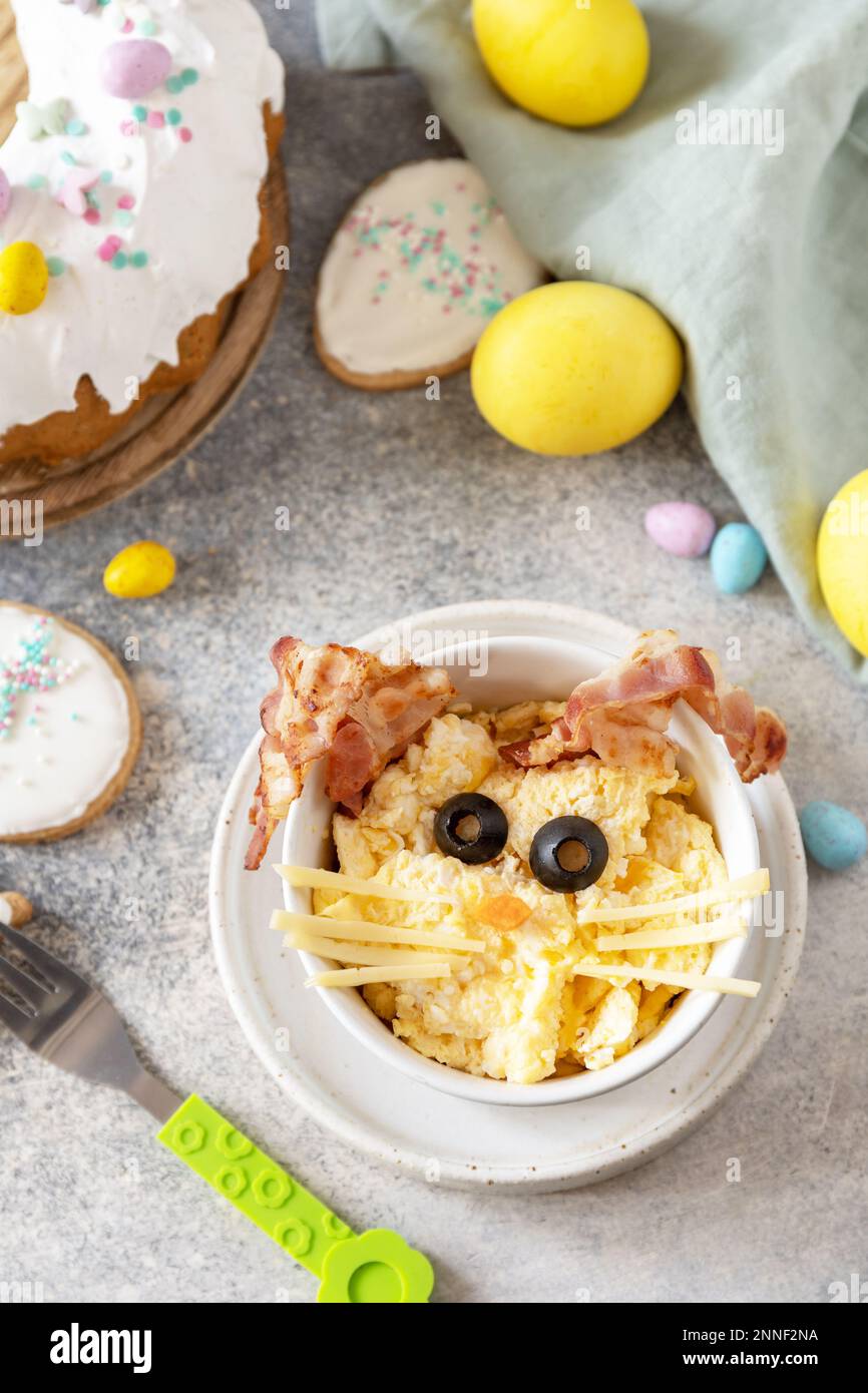 Easter breakfast idea. Scrambled eggs easter bunny on a stone background. Stock Photo