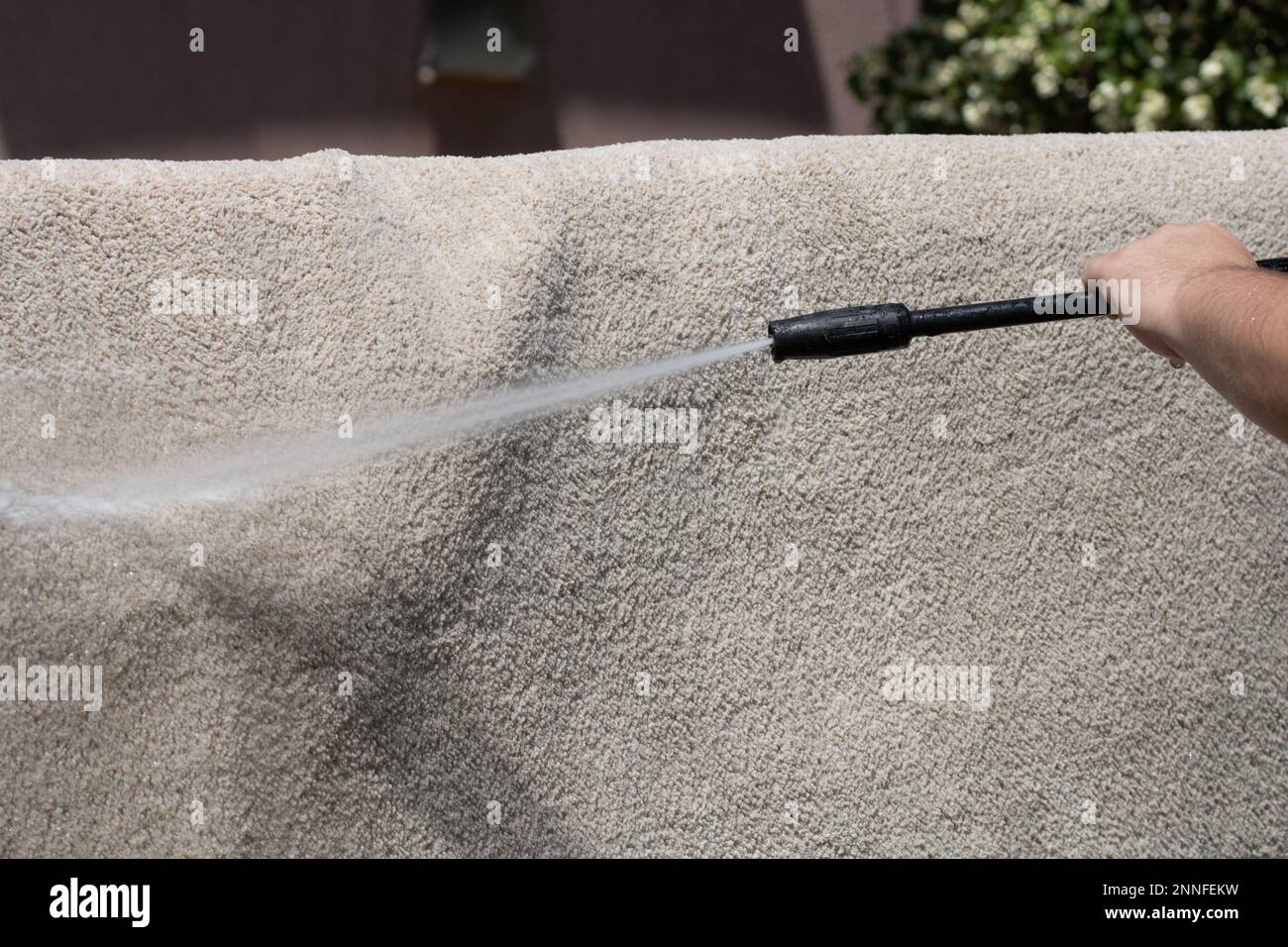 Washing carpets with high pressure washer. Cleaning the carpet with a