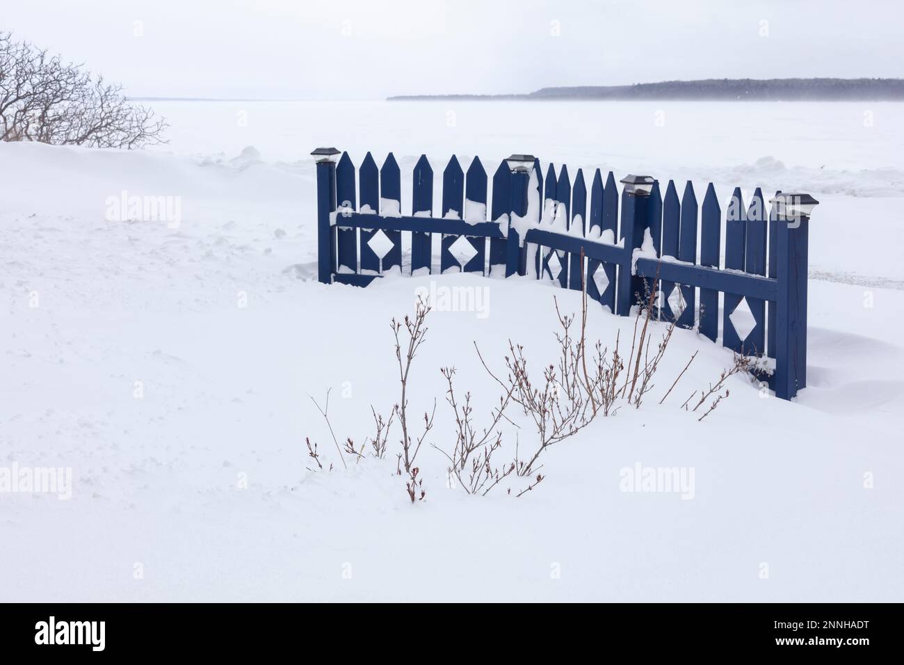 The front yard fence shows up vividly against the snowy wasteland of Manitoulin Island, Ontario. Stock Photo