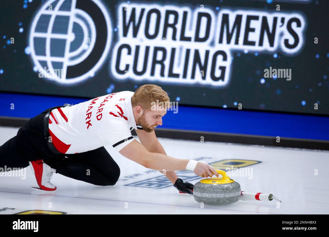 Denmark skip Mads Norgaard makes a shot against Germany at the mens World Curling Championships in Calgary, Alberta, Tuesday, April 6, 2021
