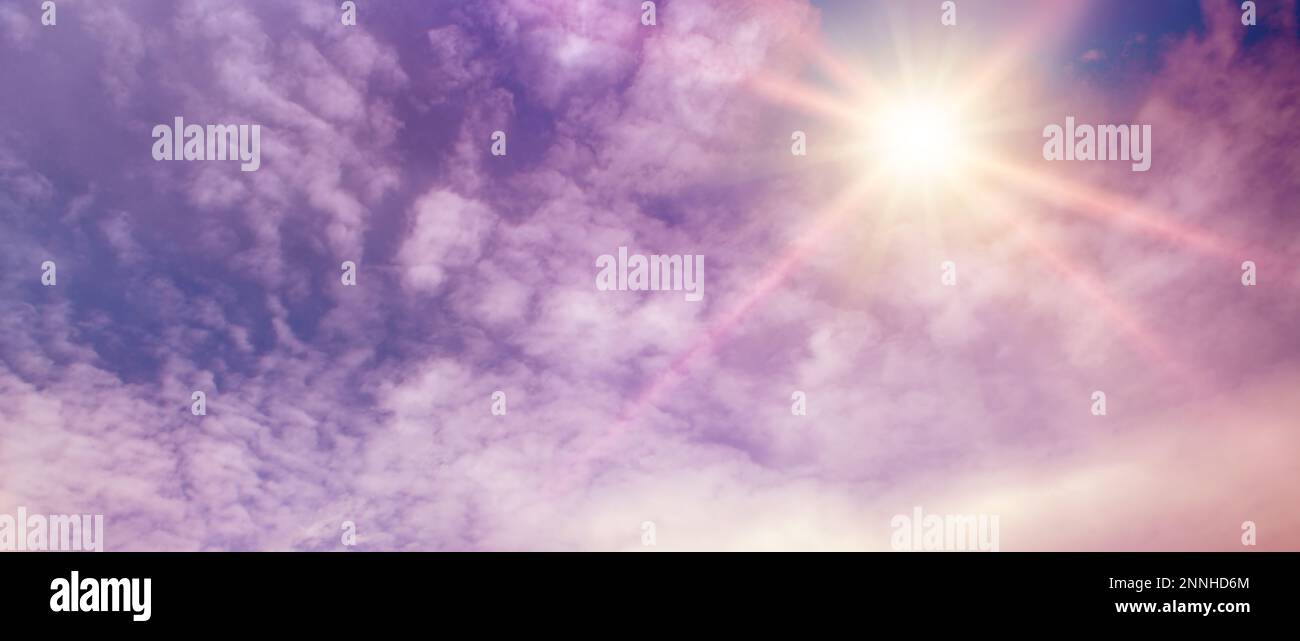 Fantastically beautiful sky in lilac tones and bright sun. Stock Photo