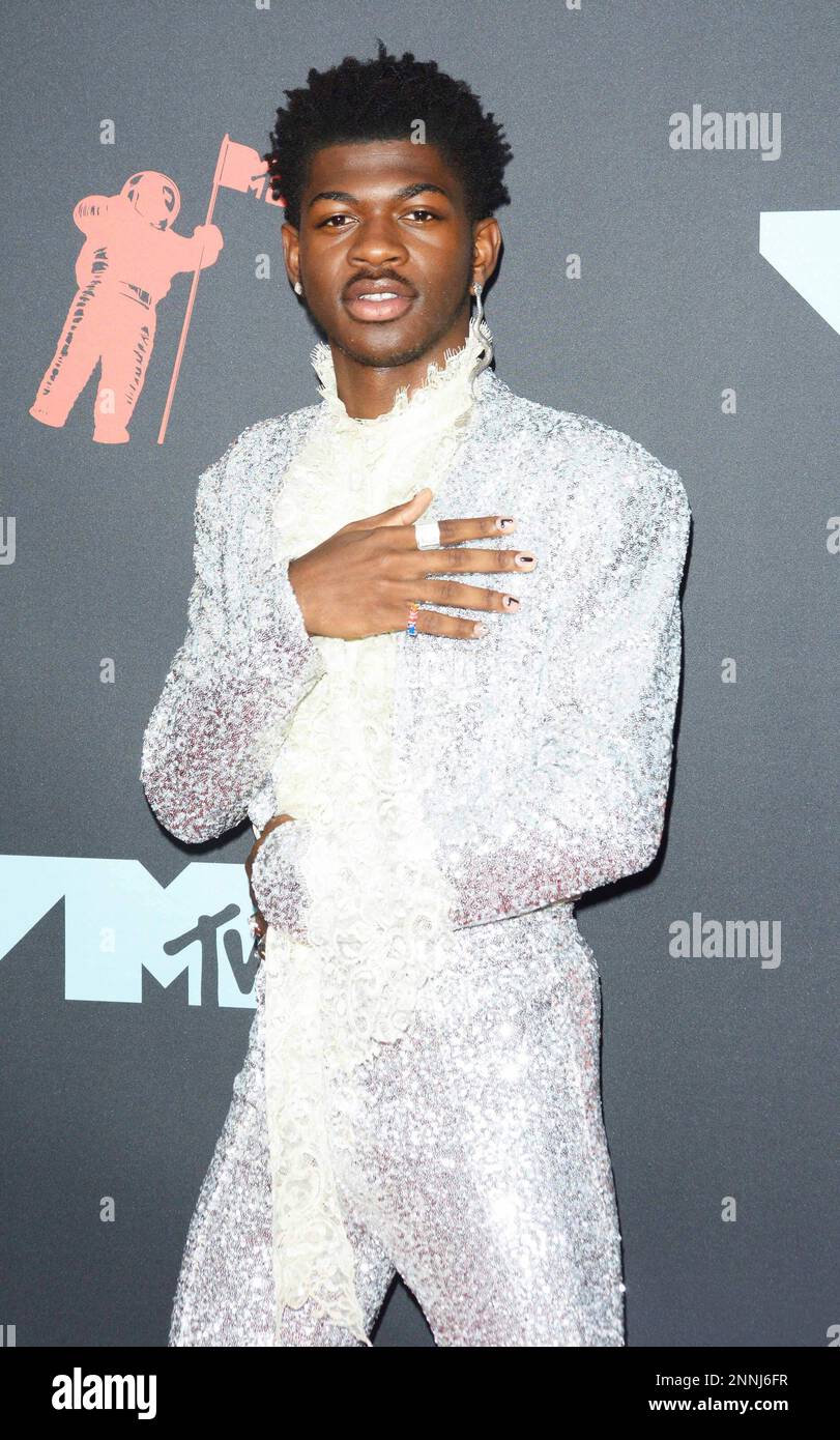 Photo by: Patricia Schlein/STAR MAX/IPx 2021 3/31/17 Nike sues over Lil Nas  X 'Satan Shoes' with human blood in soles. STAR MAX File Photo: 8/26/19 Lil  Nas X at the 2019 MTV