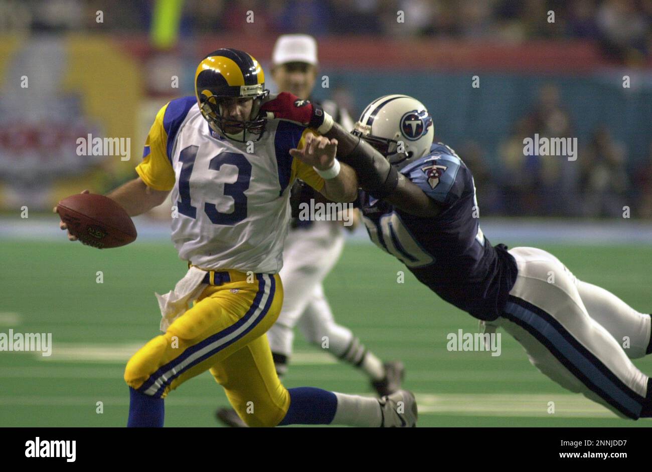 JANUARY 30 2000: Rams quarterback Kurt Warner (13) is tackled by the face  mask by Titans defense end Jevon Kearse as the St. Louis Rams defeated the  Tennessee Titans 23-17 to win