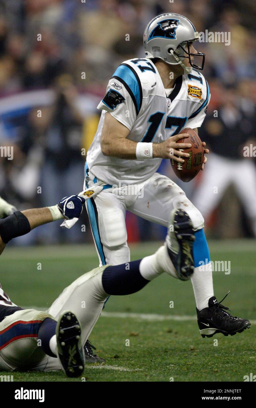 01 Feb 2004: Jake Delhomme of the Carolina Panthers fights off a tackler  during the New England Patriots 32-29 win over the Carolina Panthers in  Super Bowl XXXVIII at Reliant Stadium in