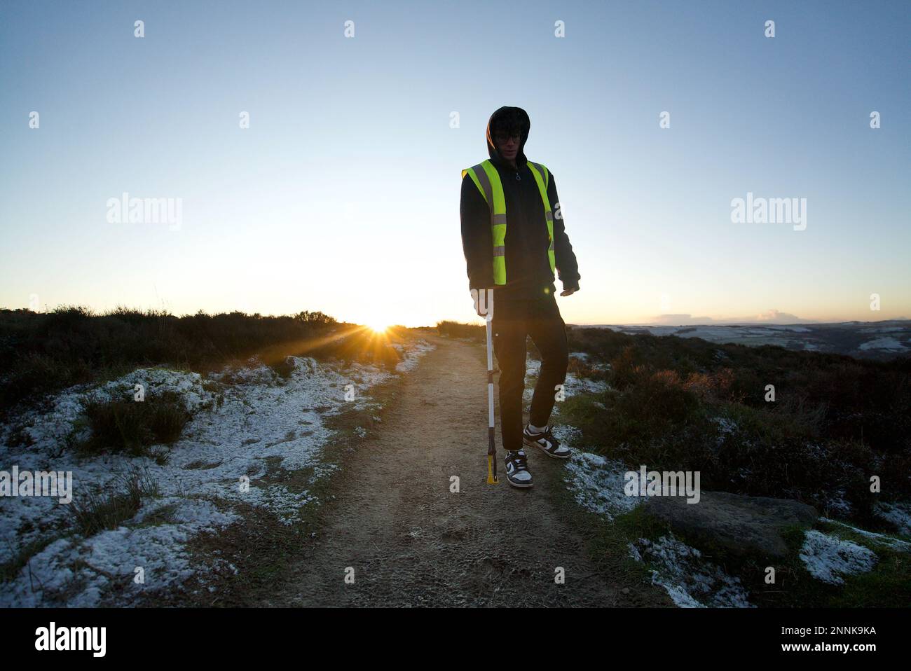 A man picking up litter in the Peak District, along Baslow Edge at
