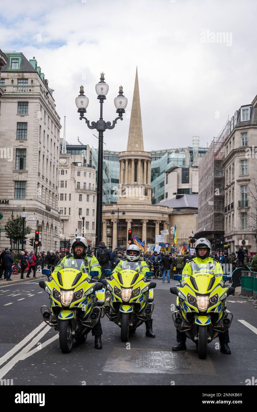 Police on motorbikes in front of the Stop the War coalition demonstration outside the BBC’s Broadcasting House,  London, UK 25/02/2023 Stock Photo