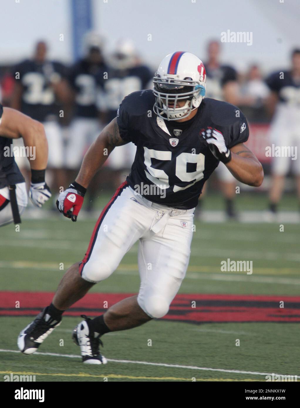 Buffalo Bills defensive end Aaron Schobel takes a rest on a blocking dummy  before Wednesday's practice at St. John Fisher College in Rochester, NY.  (Credit Image: © Michael Johnson/Southcreek Global/ZUMApress.com Stock  Photo 