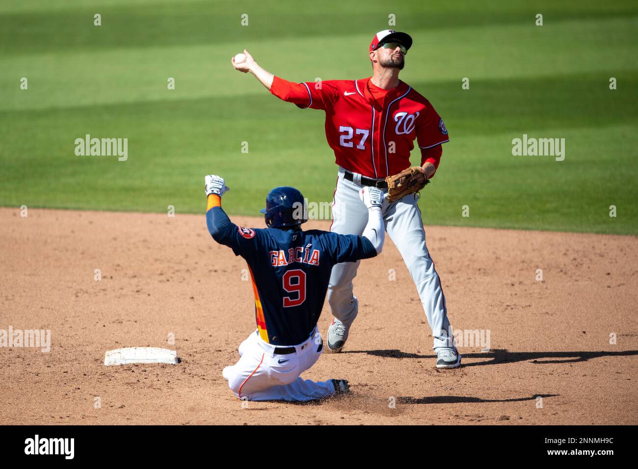 WEST PALM BEACH, FL - MARCH 14: Washington Nationals non-roster invitee  infielder Jordy Mercer (27) tags out Houston Astros infielder Robel Garcia  (9) at second base and throws the ball to first