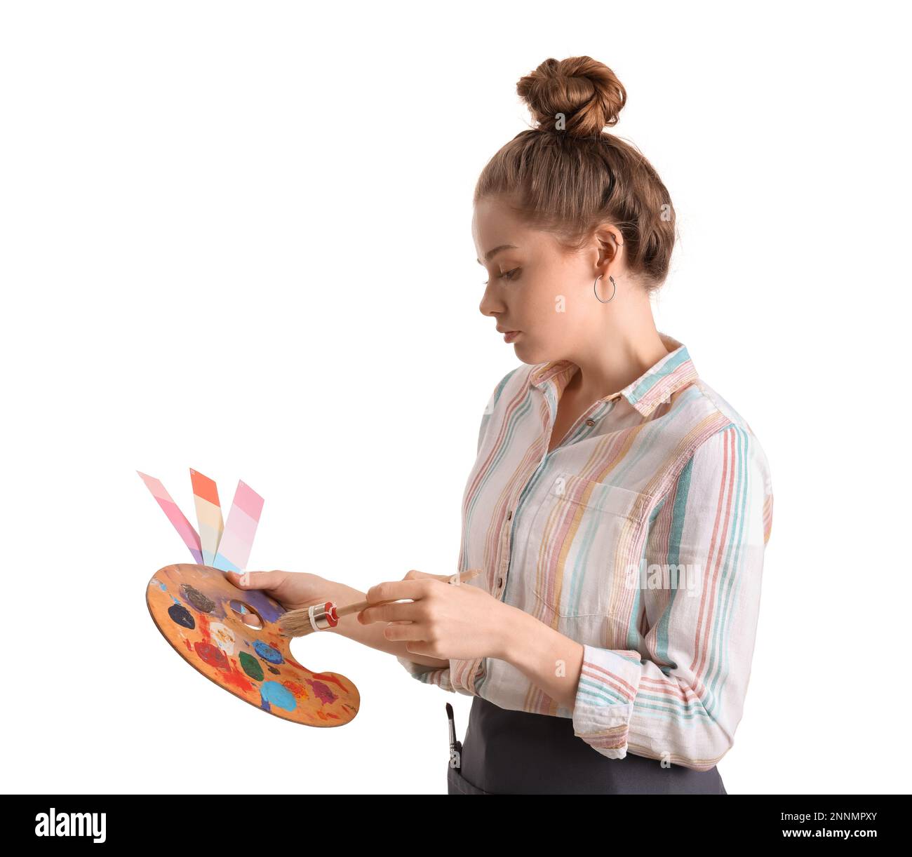 Female artist with brush, color samples and paint palette on white ...