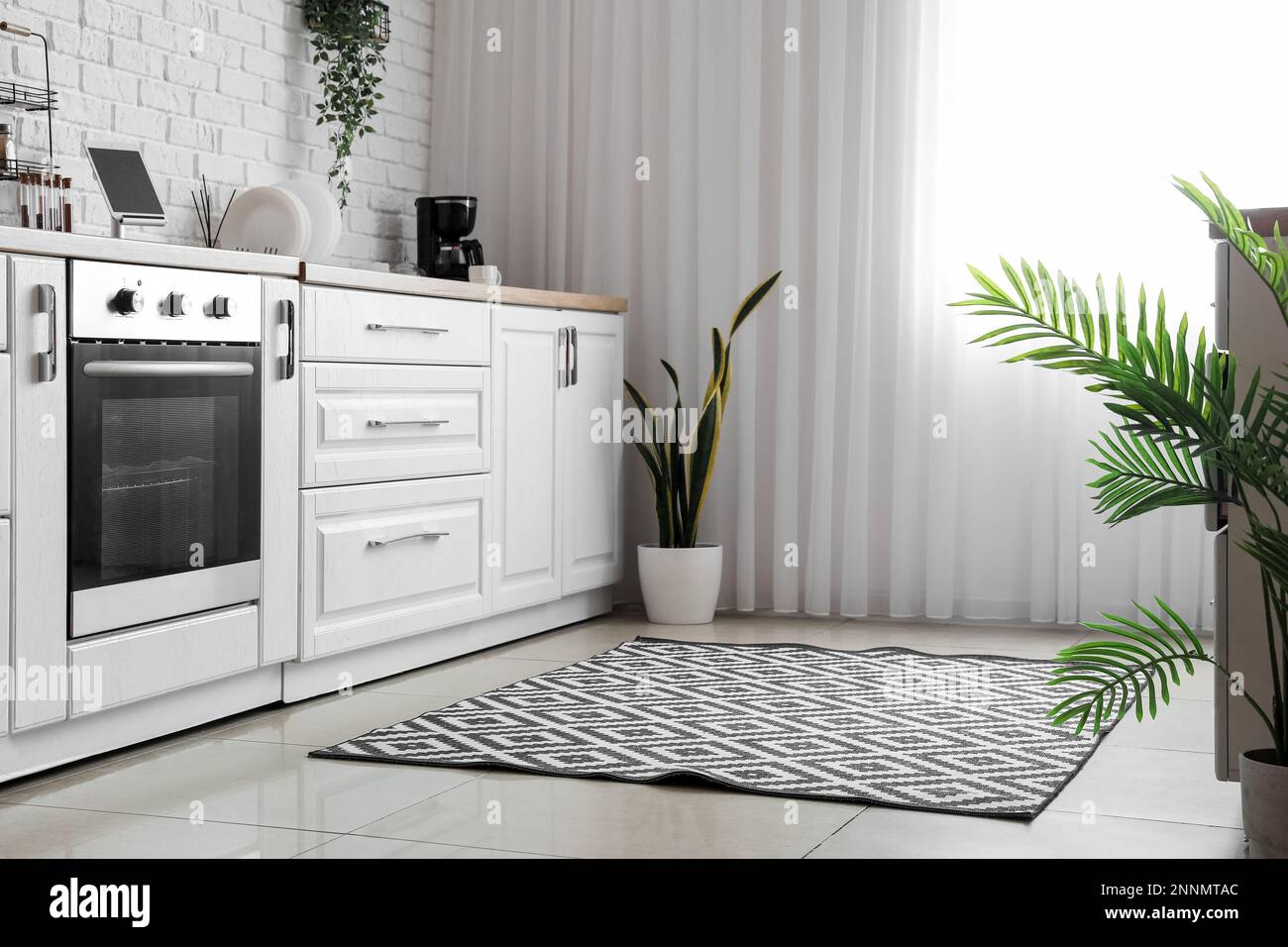 Interior of light kitchen with white counters and electric oven Stock ...