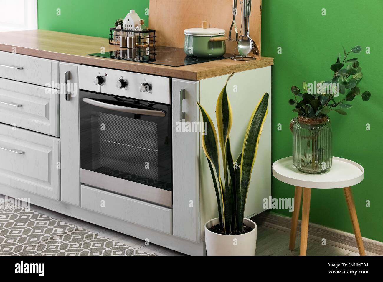Modern electric oven with stove in interior of kitchen Stock Photo - Alamy