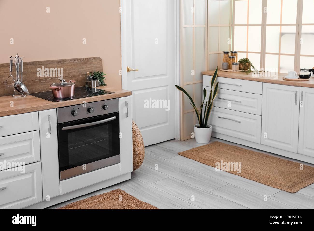 Interior of modern kitchen with white counters and electric oven Stock ...