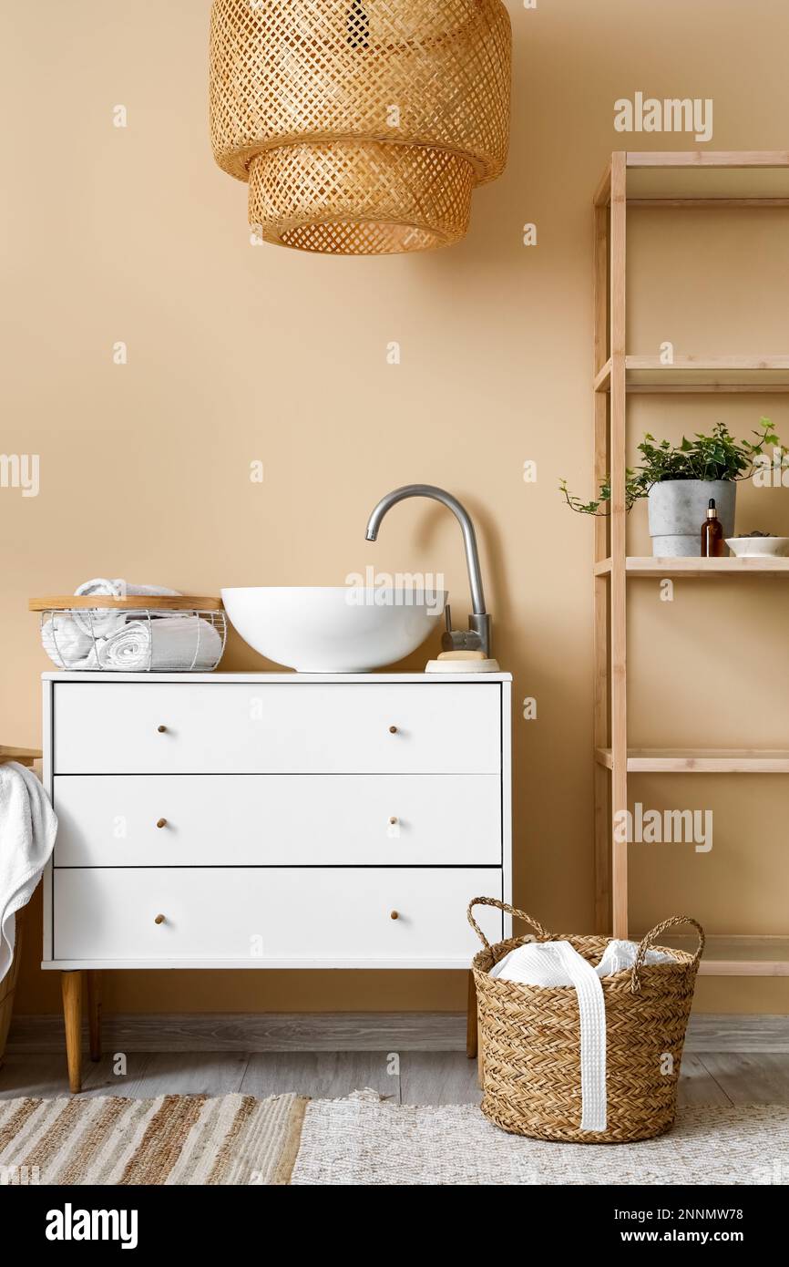 Interior of bathroom with sink, drawers and shelving unit Stock Photo ...
