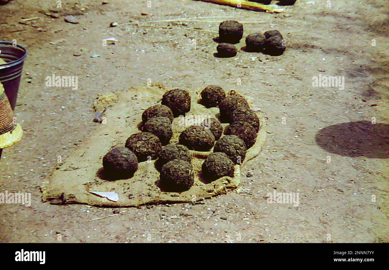 Balls of tobacco on sale at an outdoor market in Bolgatanga, Ghana c.1958 Stock Photo