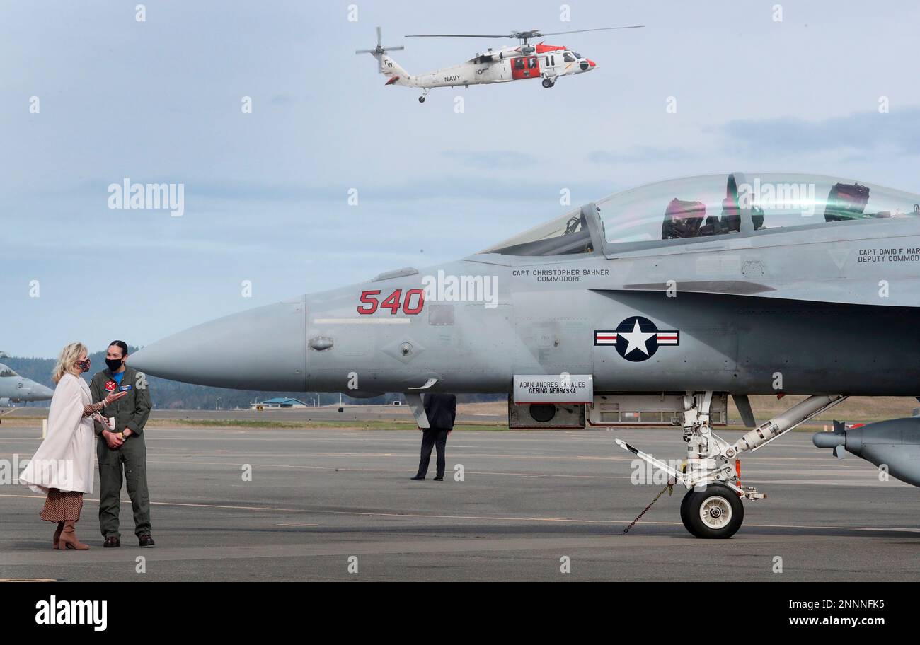 First lady Jill Biden, left, is given a tour of a Growler aircraft by
