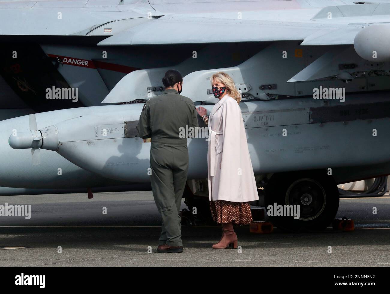 First lady Jill Biden, right, is given a tour of a Growler aircraft by