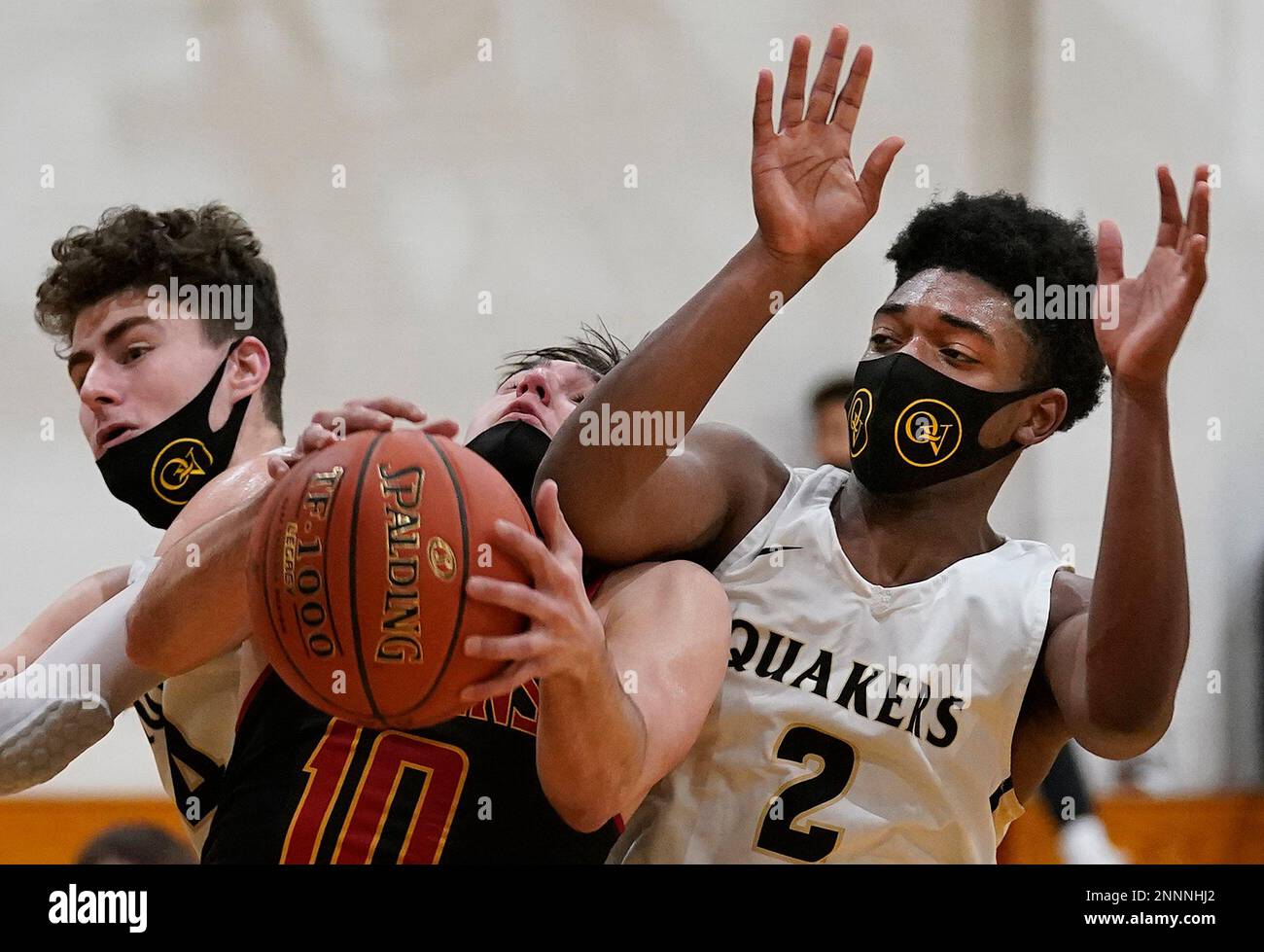 North Catholic's Matt Gregor battles Quaker Valley's Malcolm Jordan for a  rebound during a basketball game Monday, March 8, 2021, at Quaker Valley  High School in Leetsdale, Pa. (Peter Diana/Pittsburgh Post-Gazette via