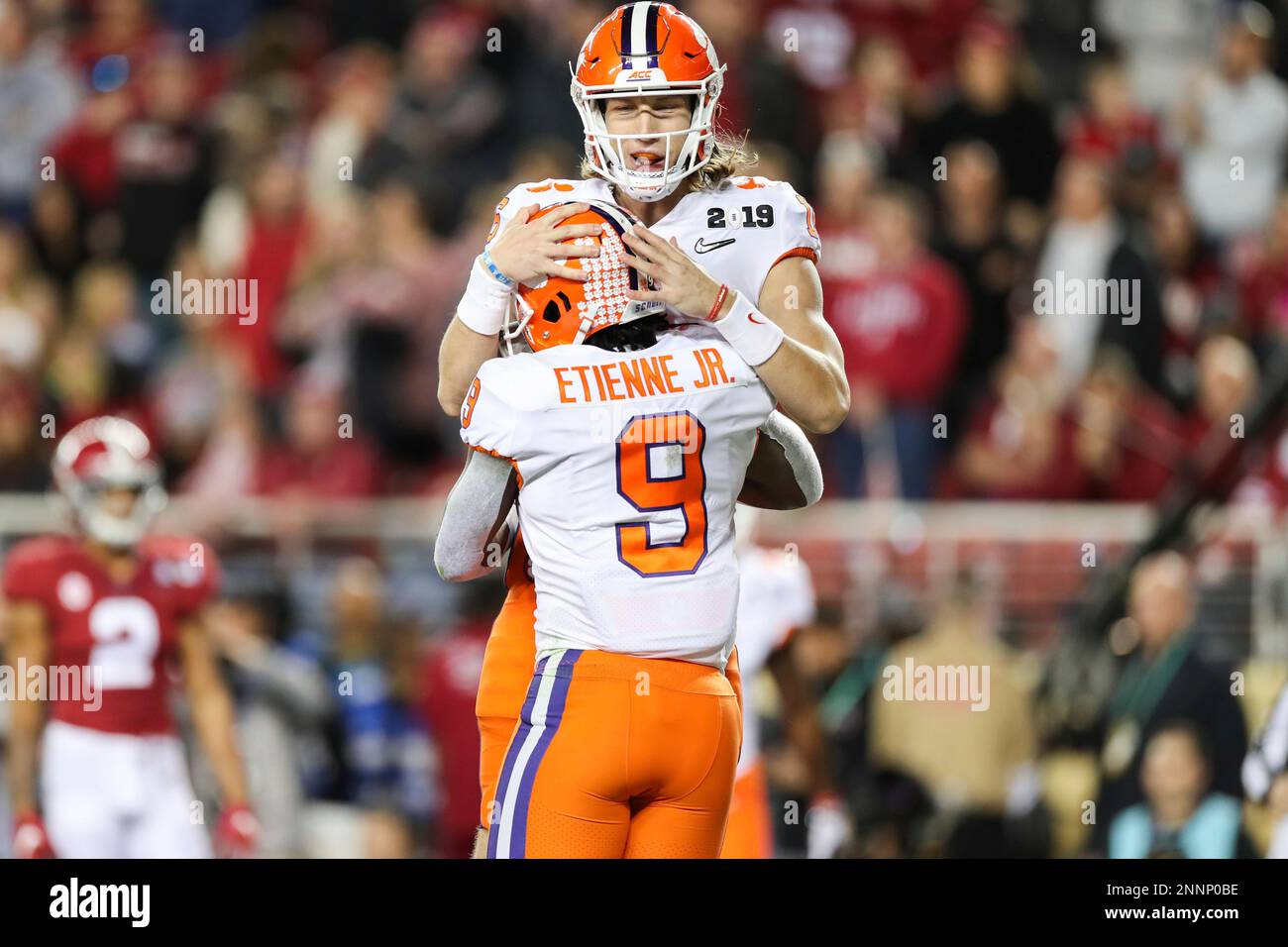 Clemson Tigers quarterback Trevor Lawrence (16) celebrates with running  back Travis Etienne (9) during an NCAA