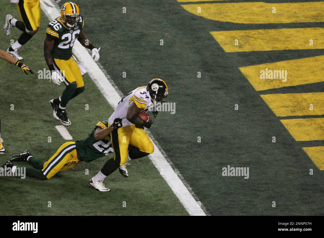 Green Bay Packers cornerback Pat Lee (R) dives to tackle Pittsburgh Steelers  running back Rashard Mendenhall in the third quarter during Super Bowl XLV  at Cowboys Stadium in Arlington, Texas on February