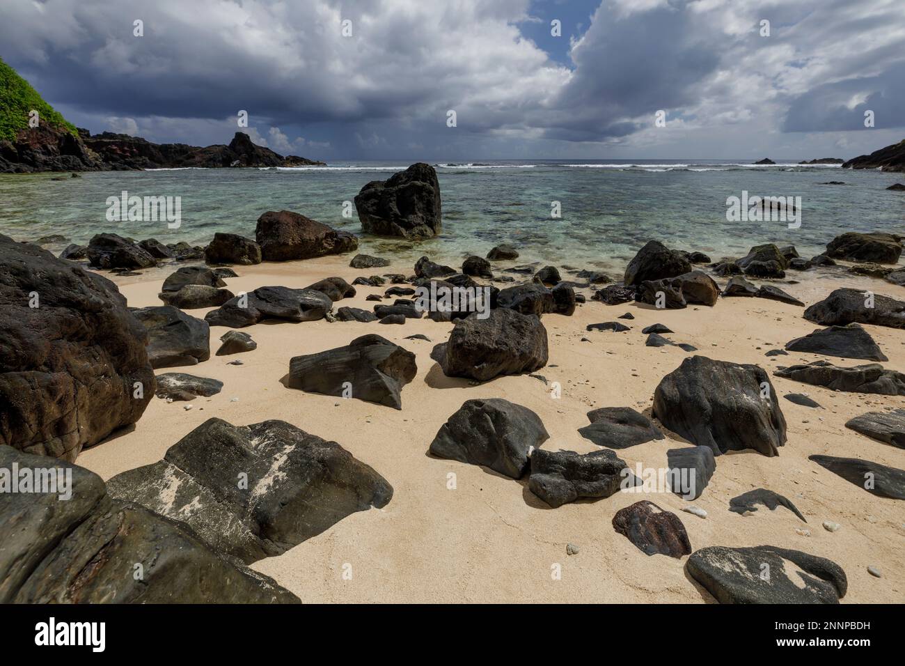 Black rock and white sand beaches along the coast of Amanave village, Tutuila, American Samoa Stock Photo
