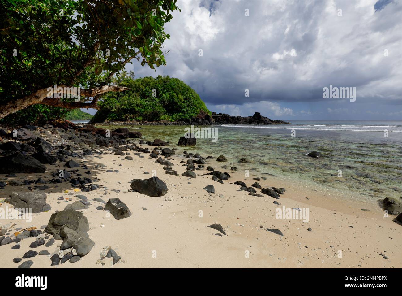 Black rock and white sand beaches along the coast of Amanave village, Tutuila, American Samoa Stock Photo
