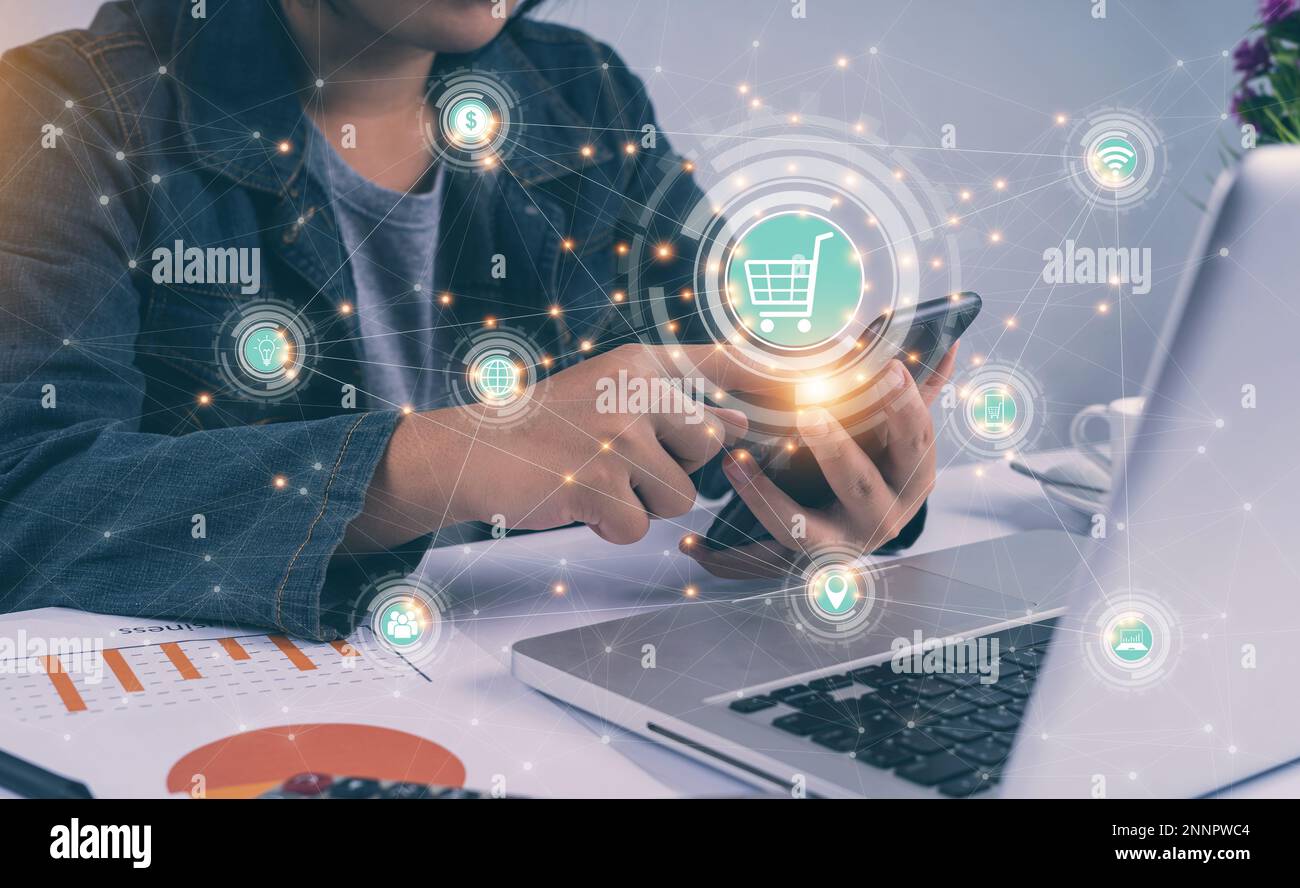 People hands using smartphone and laptop with online banking network icon screen. Online payment digital and shopping online. marketing, financial. Gl Stock Photo